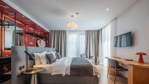 A modern hotel room with a large bed, a desk, and a TV. - Artifact Apart Hotel  (Tbilisi)