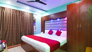 Ein modernes Schlafzimmer mit einem großen Bett, einem Holzschrank und einem Deckenventilator.