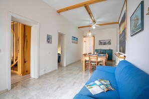 Family Apartment, Multiple Bedrooms (Brezza Apartment Near The Sea) | Living area | 21-inch TV with cable channels