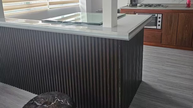 A modern kitchen with a central island, a built-in oven, and a gas stove. - Loft Type Apartment. Bogotá Concejo (Bogotá)