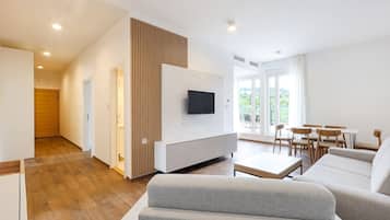 Deluxe Apartment | Living area | 40-inch LED TV with digital channels