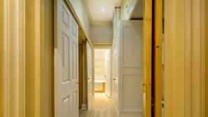 A hallway with white doors and a wooden door frame. - The Vintage - Fitzrovia - by Frankie Says (London)
