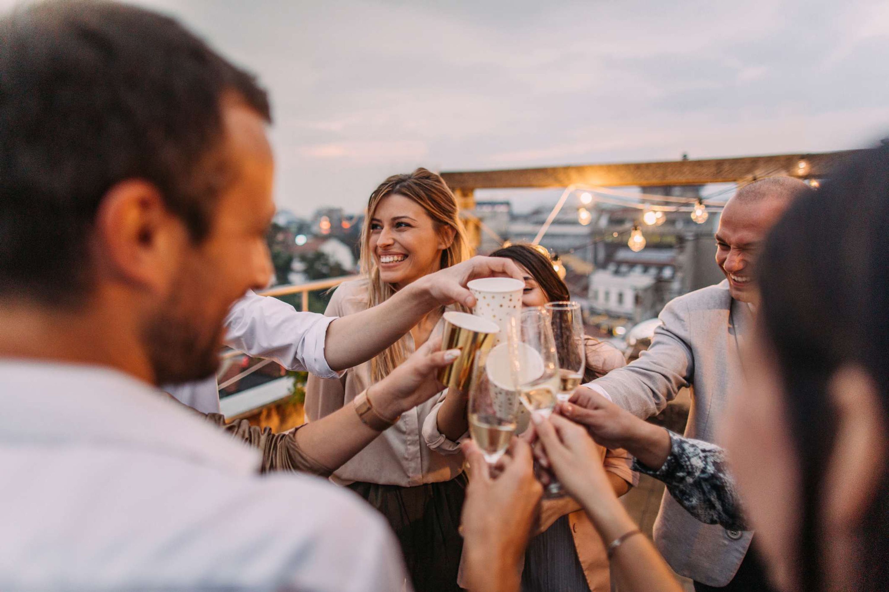 A group of people toasting with champagne glasses, suggesting a celebratory event.
