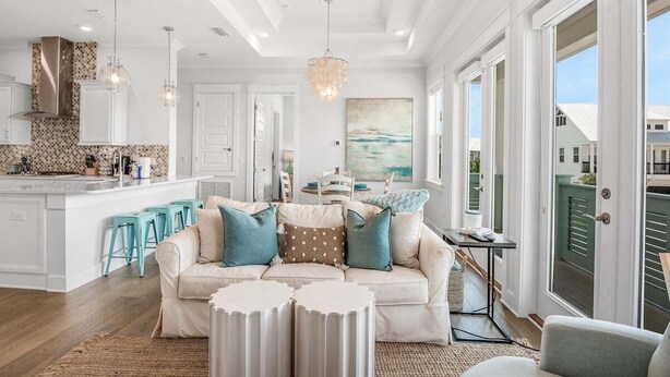 A modern kitchen with white cabinetry, a central island, and teal bar stools. - 🔆 Golf Cart | Bikes | The Big Chill | Resort Pools ​​​​​​ (Inlet Beach)