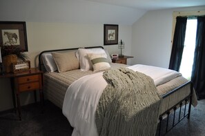 Cozy retreat with a neatly made bed, two nightstands, and a peaceful atmosphere.