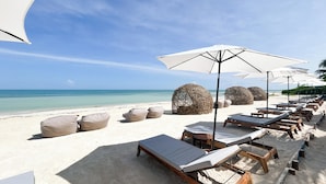 A beach with lounge chairs and umbrellas, a sandy beach, and the ocean in the background. - Ana y Jose Holbox Boutique All Inclusive Hotel (Isla Holbox)