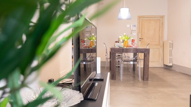 A dining area with a wooden table, chairs, and a hanging light fixture. - Tuscany Dream - Two Bedroom House, Sleeps 3 (Arezzo)