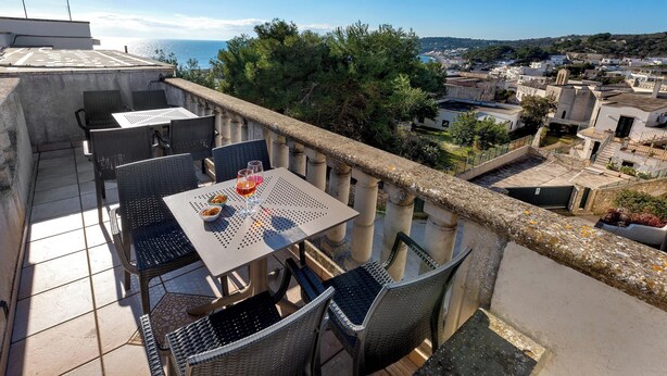 A terrace with outdoor seating and a view of the sea. - Casa Pireddu by BarbarHouse (Castro)