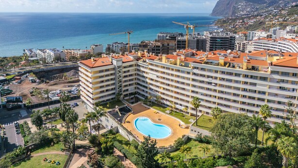 A hotel with a pool, multiple floors, and a view of the ocean. - Lux Garden View by Madeira Sun Travel (Funchal)