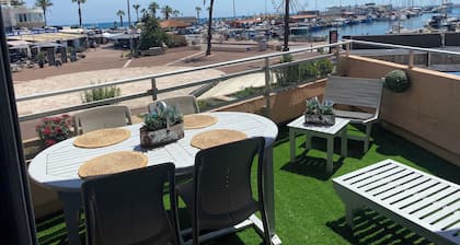 Studio with terrace overlooking sea, port and mountains.