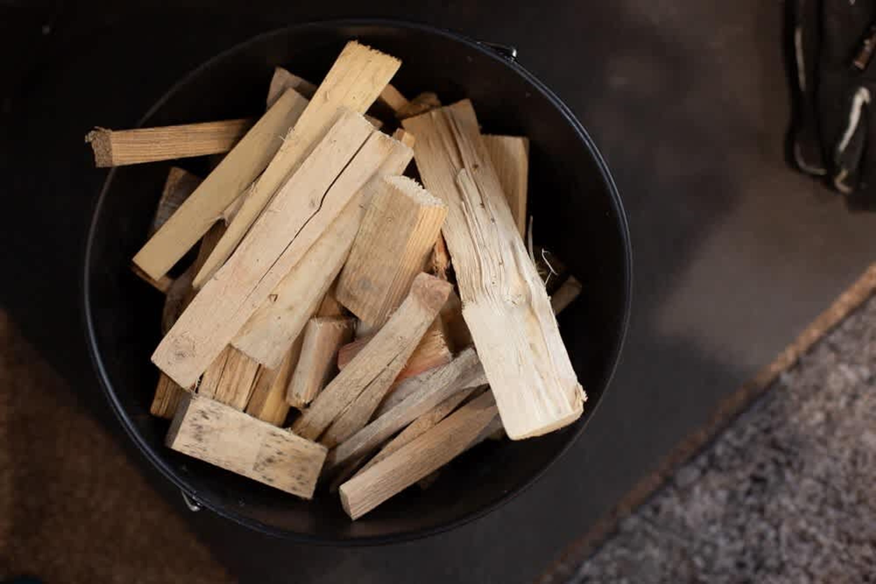 A bucket filled with firewood.