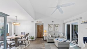 A spacious living area with a dining table, sofa, and a ceiling fan. - Charming Beach condo on the Shores at Strand Beach (Dana Point)