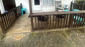 A covered porch with a wooden railing, a window with blinds, and a sign reading "Harbour Apt. 1002". - OCHG Bel Harbour Unit 1 (Ocean City)