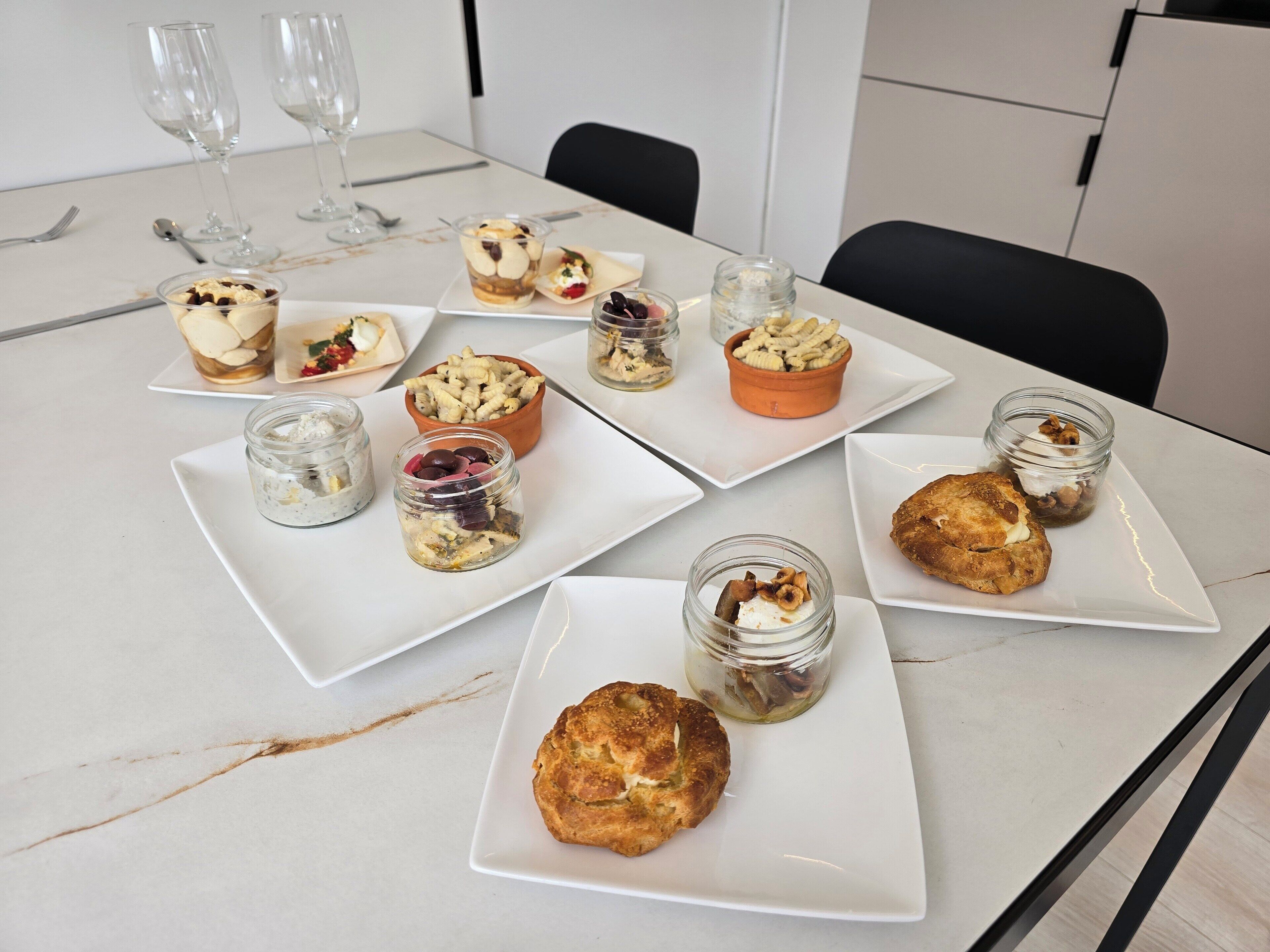 A table with various food items and glassware, likely in a dining area.