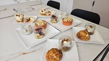 A table with various food items and glassware, likely in a dining area.