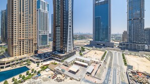 A high-rise building with a modern architectural design, featuring multiple floors and a prominent glass facade. - MBL Residence 1205 jlt (Dubai)