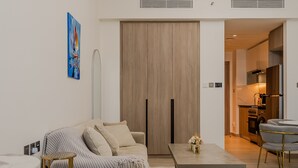 A modern living room with a sofa, coffee table, and a painting on the wall. - Me Do Re JLT 1408 in Dubai (Dubai)