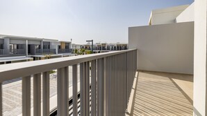 A modern building with a flat roof and a white railing. - Tilal AL Ghaf 245 in Dubai (Dubai)