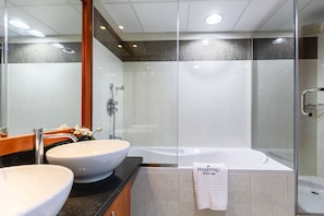 A modern bathroom with two sinks, a bathtub, and a glass shower enclosure. - Park Towers B 001204 (Dubai)