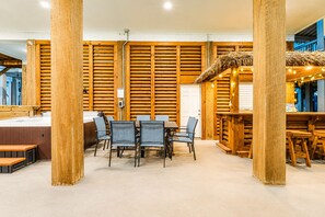A wooden interior with a dining area, a bar, and a reception desk. - Beach View | Hot Tub | Sleeps 14 + Hammock (Crystal Beach)