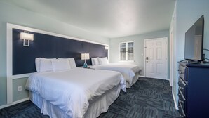 A hotel room with two beds, a dresser, and a window with blinds. - Deluxe Studio Suite, 2 Queen Beds, Lake View, Ground Floor (Hot Springs)