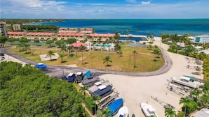 A resort with multiple buildings, a swimming pool, and a beach area.