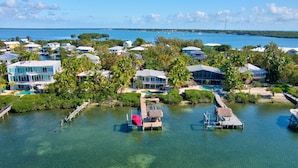 An aerial view of a coastal resort with multiple buildings, clear waters, and a dock. - Lime Key in Key Largo (Key Largo)