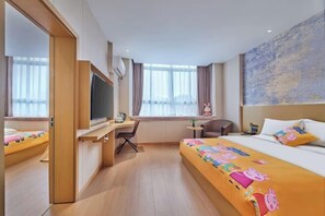 A hotel room with a bed, a desk, a chair, a television, and a window with curtains. - Yiju Qingyue Hotel (Xishui)