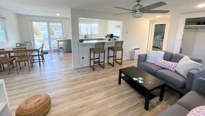 A modern apartment with a dining area, kitchen, and living room. - 10 Braddock Somers Point (Somers Point)