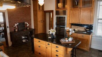 A kitchen with wooden cabinets, a central island, and a stainless steel oven.