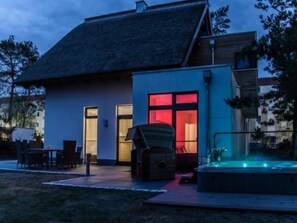 Relax in style with a hot tub and outdoor seating area.