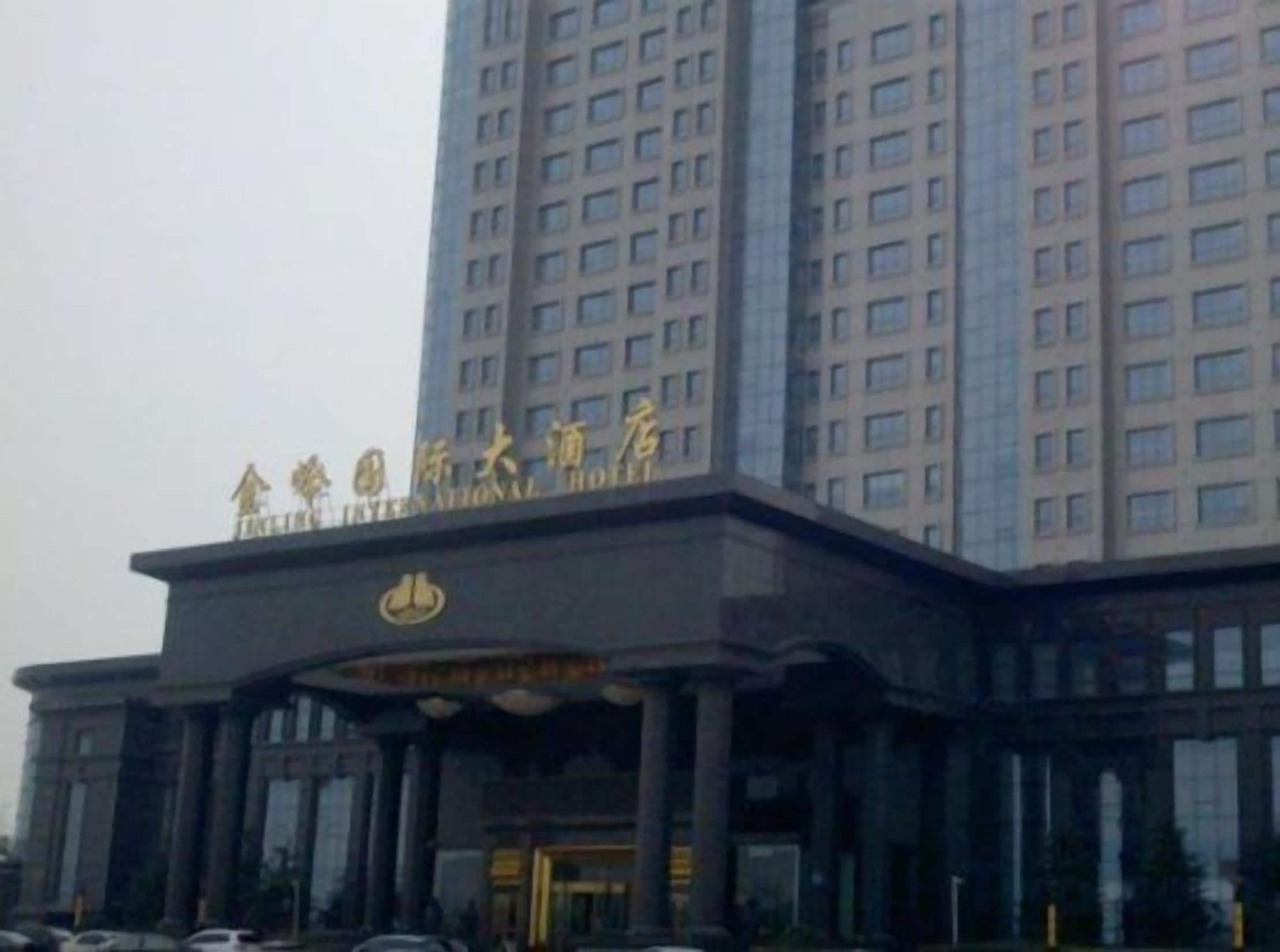 A hotel with a prominent entrance and a large sign above the doors.