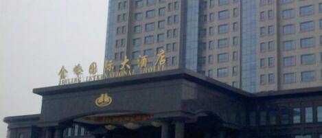 A hotel with a prominent entrance and a large sign above the doors.