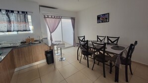 A modern kitchen with a dining area.