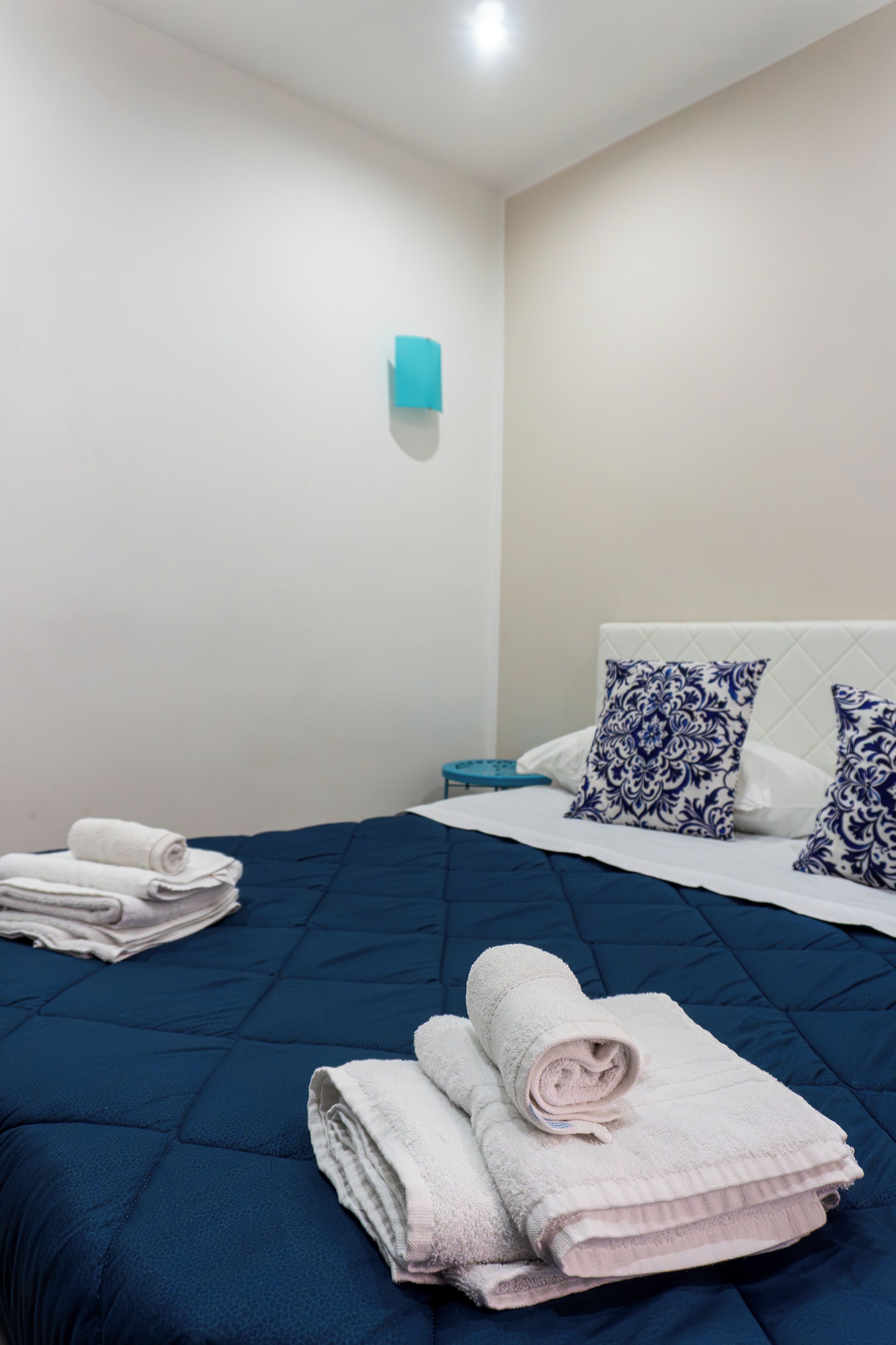 Ein Hotelzimmer mit einem Bett, Kissen und gefalteten Handtüchern.