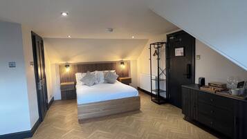 A modern bedroom with a wooden bed, a black wardrobe, and a wooden floor.