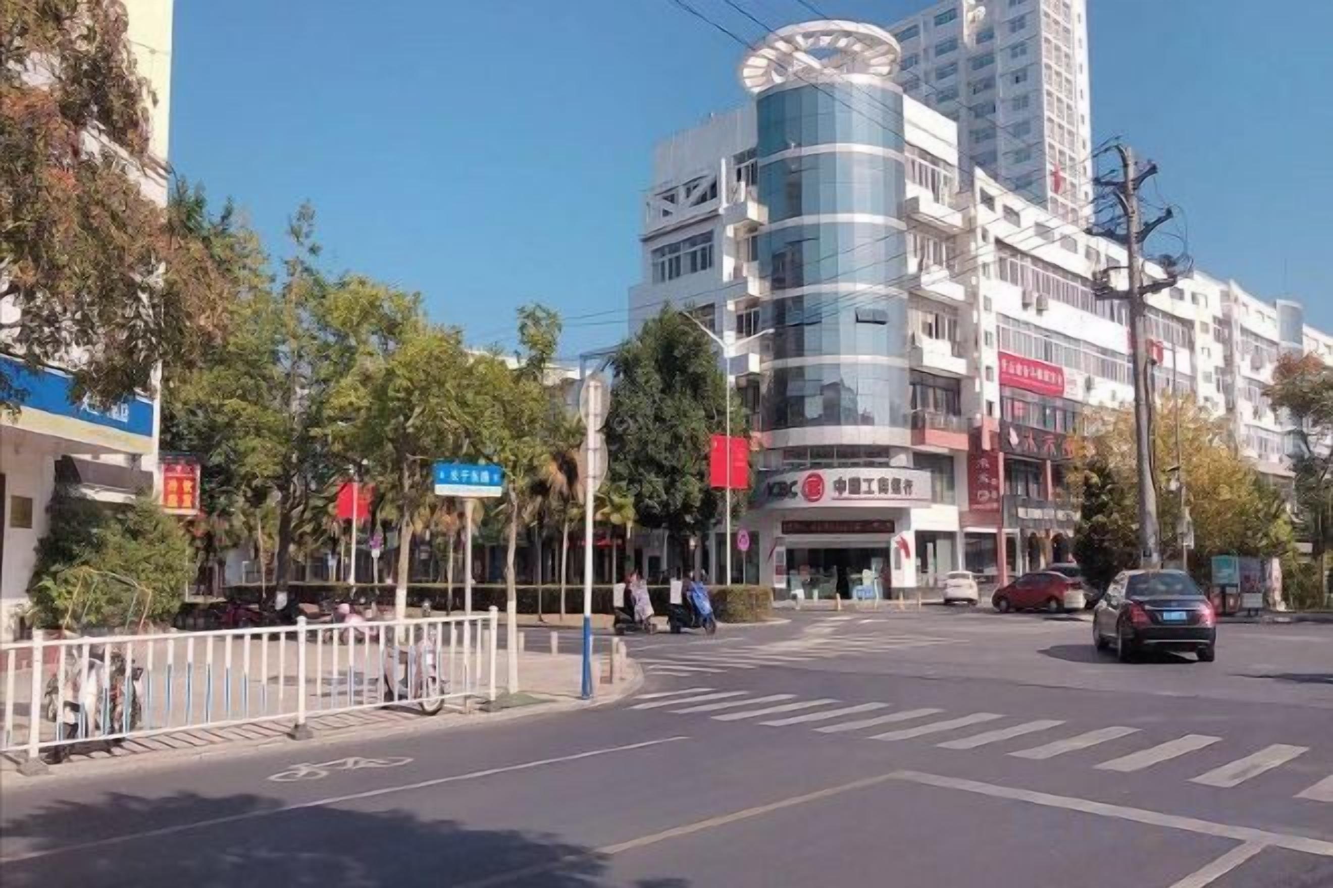 A multi-story building with a modern design, featuring a curved facade and a mix of commercial and residential spaces.