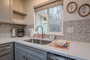 A kitchen with a double sink, a coffee maker, and a dish soap bottle. - Juliet II Rental: Near Downtown & Trail Heads (Grand Junction)
