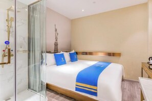 A hotel room with a bed, a shower, and a statue on the wall. - Super 8 Plus Hotel (Beijing Tiananmen Square Qianmen Pedestrian Street) (Beijing)