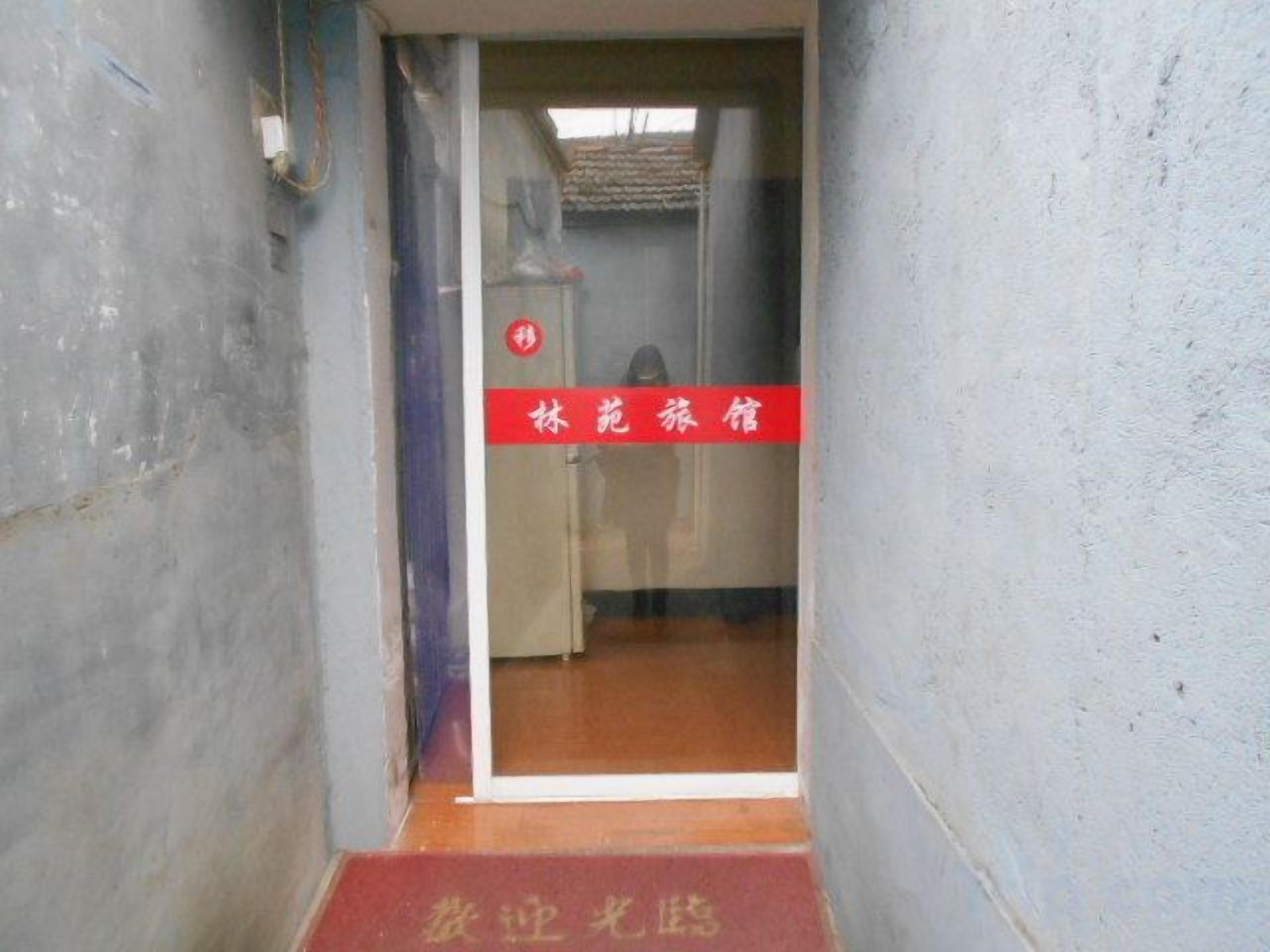 A narrow hallway with a red sign indicating a business center.