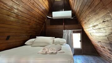 A room with a bed, a window, and an air conditioning unit.