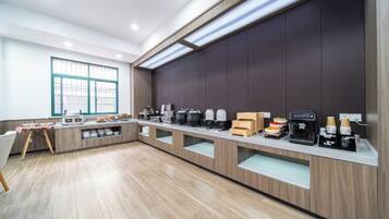 A modern kitchen with a long counter, built-in appliances, and a window providing natural light.