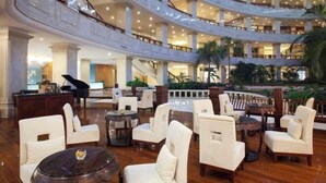 A multi-level atrium with seating areas, a grand piano, and a pool. - Zhanjiang Shanhe Hotel (Zhanjiang)