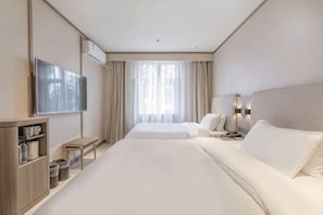 A hotel room with two beds, a TV, a desk, and a window with curtains. - HanTing Hotel (Beijing Tiantan) (Beijing)