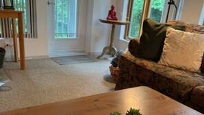 A dining table with a tray containing a cup, bowls with strawberries, and a plate with pastries. - O'Tremblant-Nature with Fireplace/Plein air avec foyer (Mont-Tremblant)