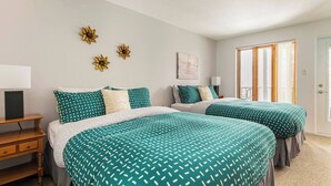A hotel room with two beds, a desk, a chair, and a window with curtains. - O'Tremblant-Nature with Fireplace/Plein air avec foyer (Mont-Tremblant)