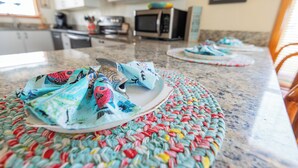 A kitchen with a granite countertop, a microwave, and cabinets. - Charming 4-bedroom house.  Walking distance to the Beach and Restaurants! (Kill Devil Hills)