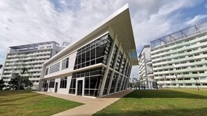 A modern building with a unique angular design, large glass windows, and a flat roof.