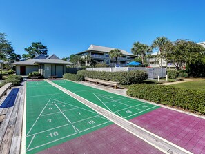 A shuffleboard court with a building in the background.