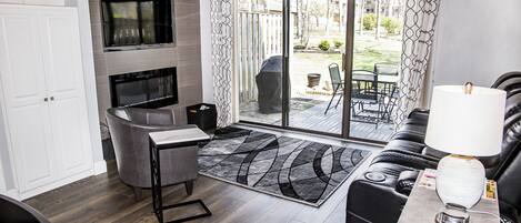 A modern living room with a TV, sofa, and a dining area.